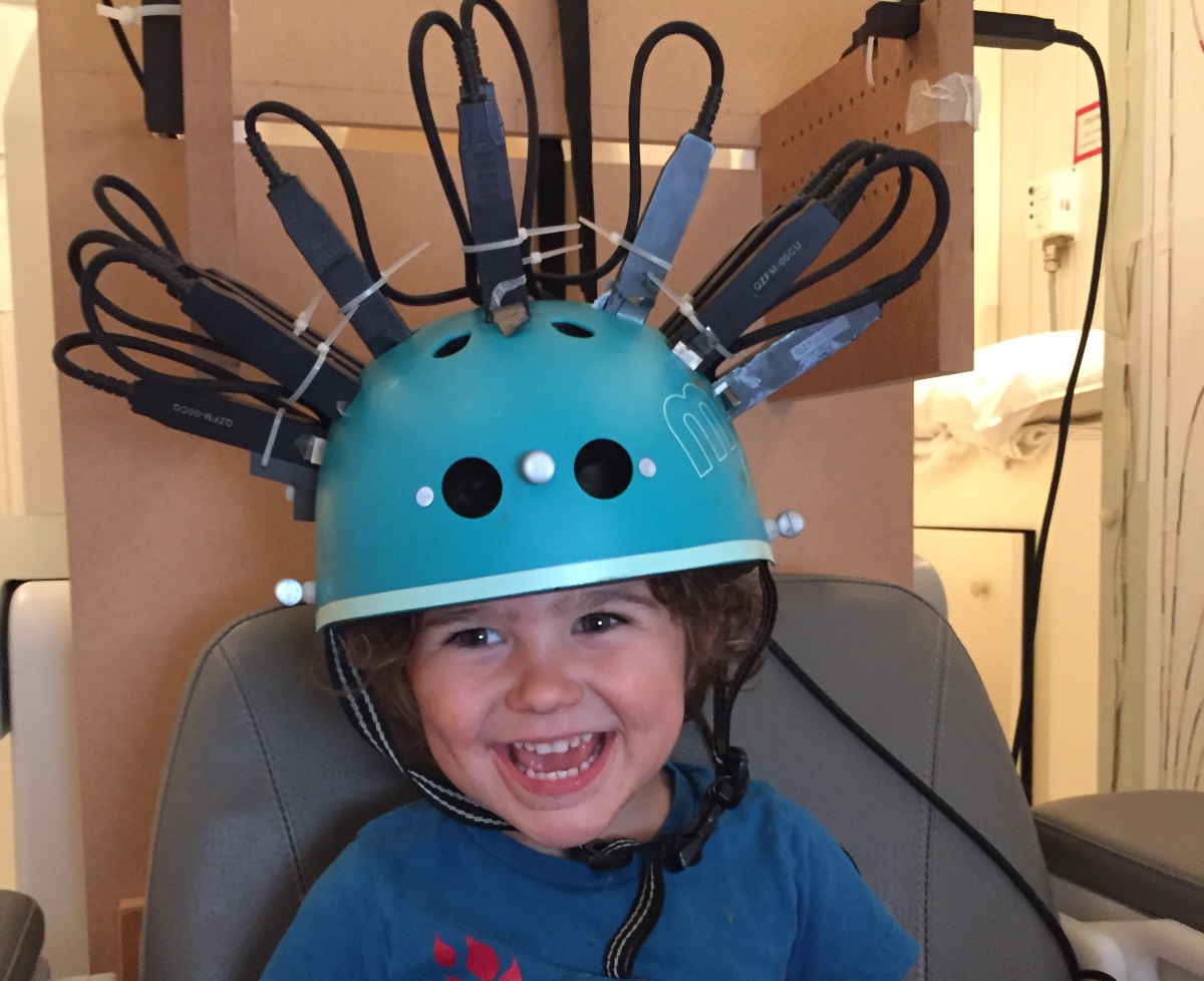 Một đứa bé hai tuổi đang được quét não bằng máy quét MEG